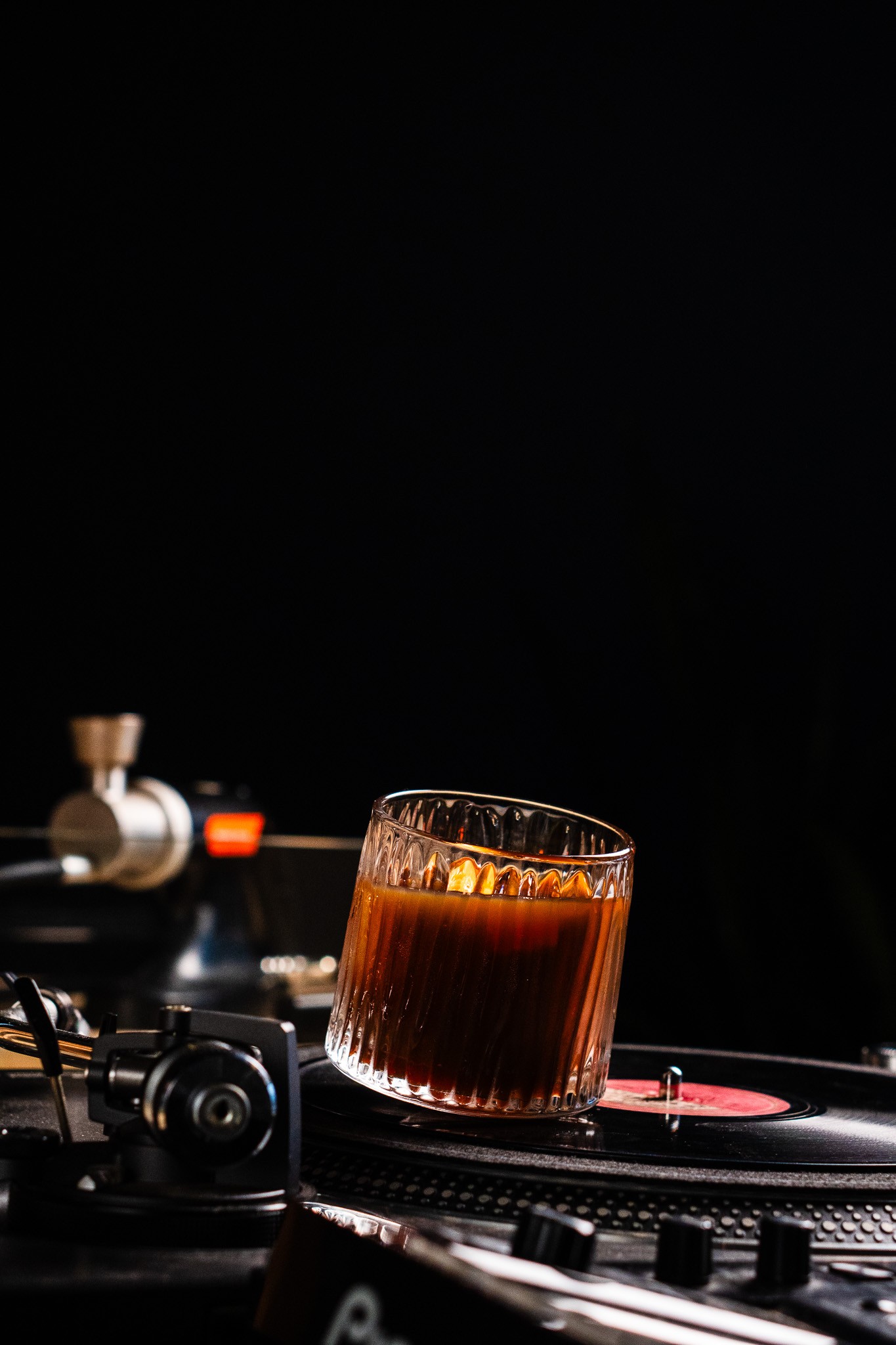 A cocktail resting on a turntable