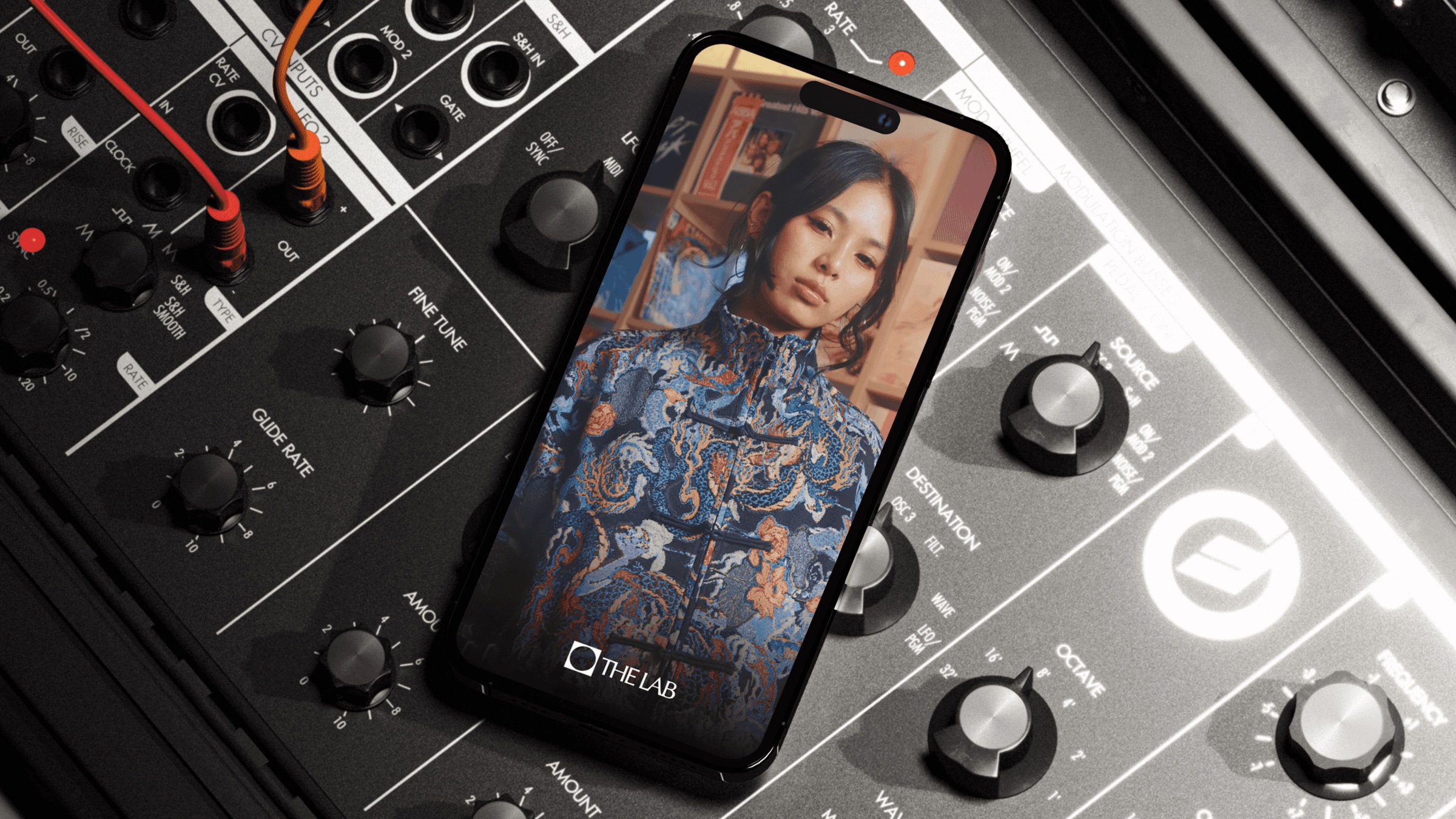 The Lab social post on a phone resting on a synthesiser